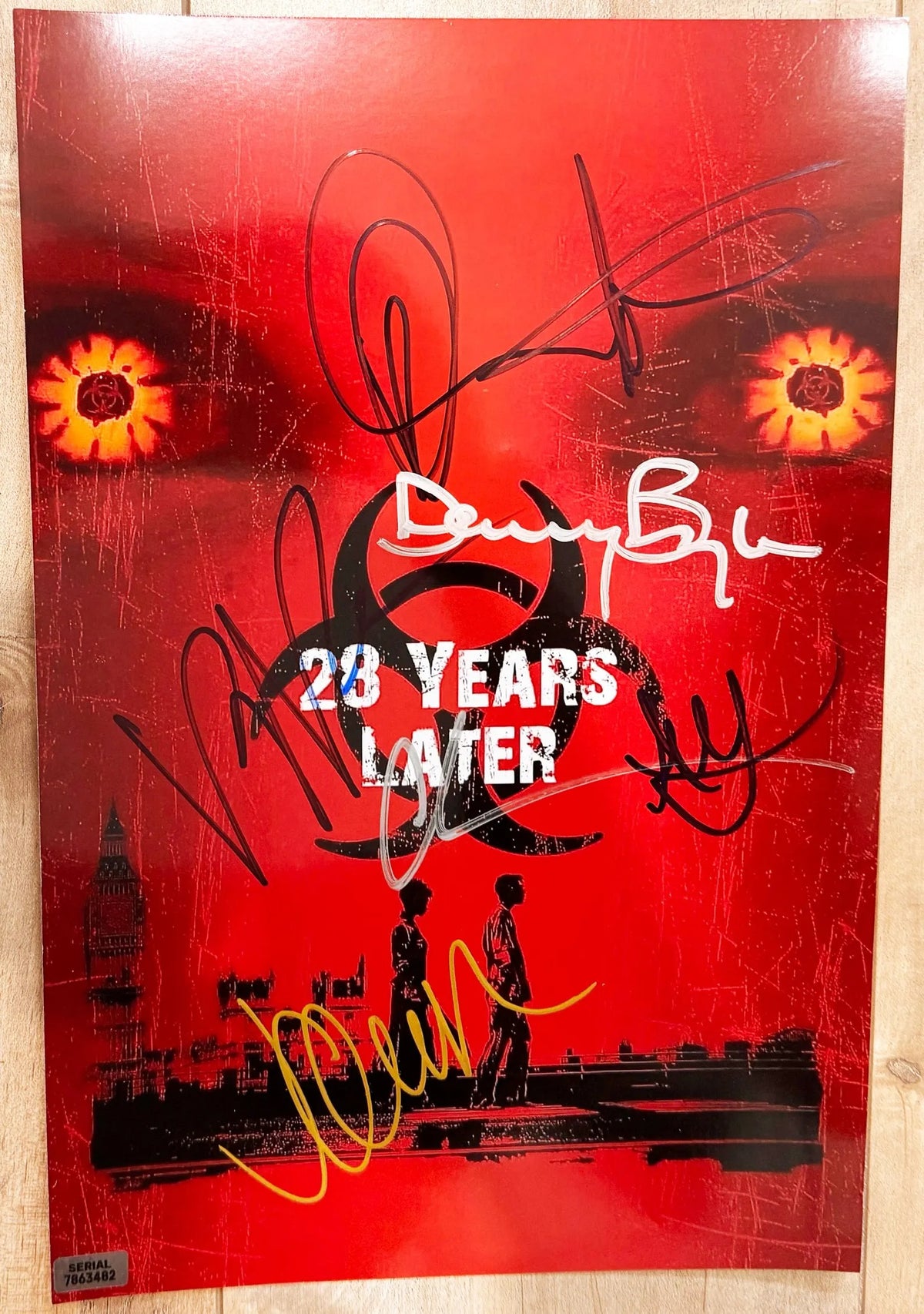 A cast autographed poster of the movie 28 Years Later. Signed photo of Jodie Comer, Ralph Fiennes, Aaron Taylor-Johnson, Jack O'Connell, Alfie Williams and Danny Boyle in silver gold and blue ink markers signatures. Photograph autographs for sale on 8x12 inch picture.