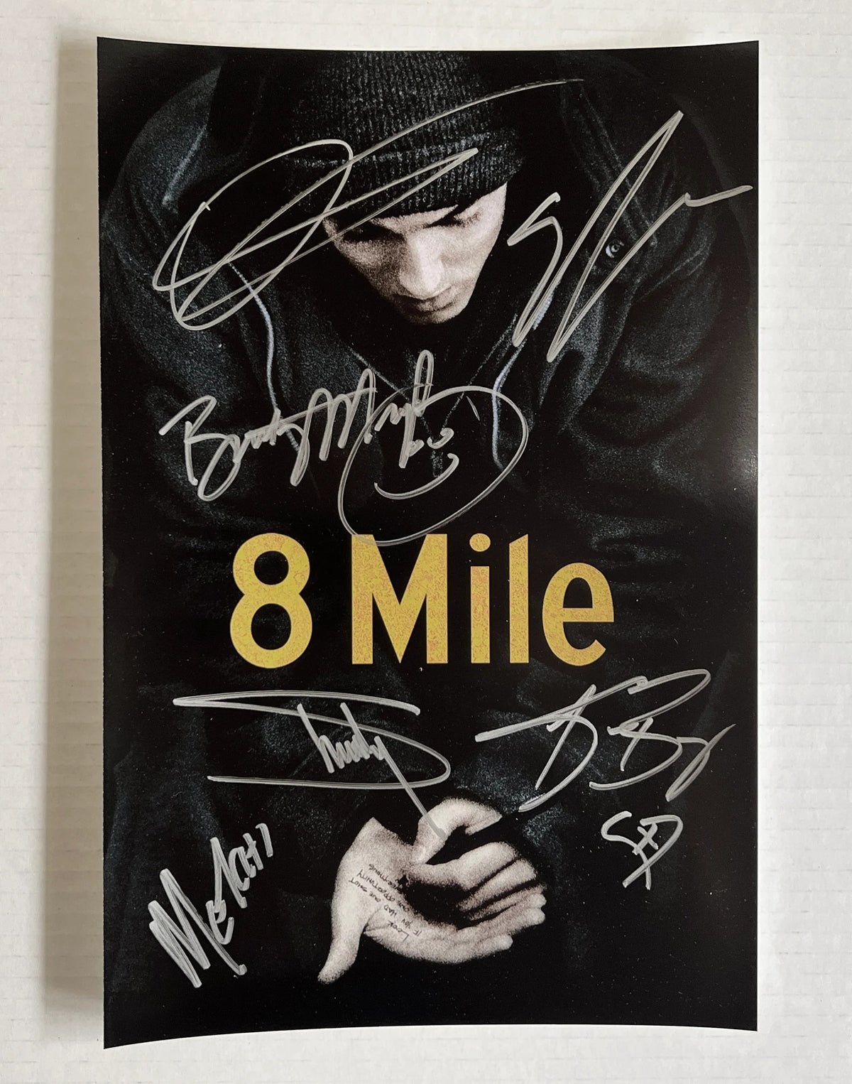 An autographed poster of movie 8 Mile. Signed photo of Eminem, Brittany Murphy, Kim Basinger, Mekhi Phifer, Evan Jones and Omar Benson Miller in silver ink marker signatures. Photograph autographs for sale on 8x12 inch picture.
