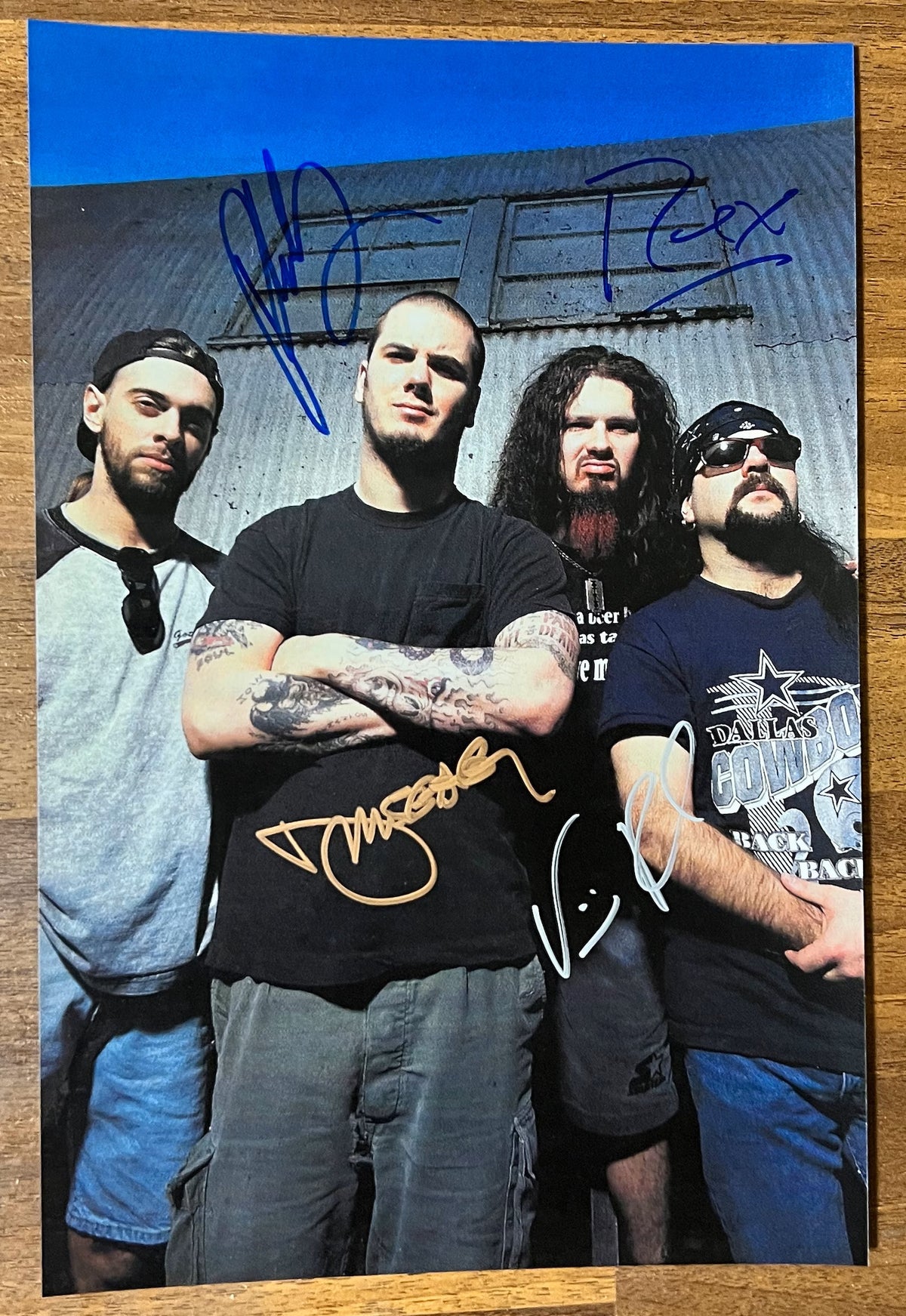 A full original lineup autographed poster of the band, Pantera. Signed photo of Dimebag Darrell, Vinnie Paul, Phil Anselmo and Rex Brown in blue gold silver ink markers signatures. Photograph autographs for sale on 8x12 inch picture.