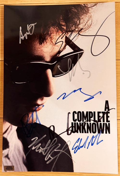 A cast autographed photo poster from the movie, A Complete Unknown. Signed photo of Timothee Chalamet, Edward Norton, Elle Fanning, Boyd Holbrook, Dan Fogler, Monica Barbaro, Norbert Leo Butz and Scoot McNairy in blue black and silver ink marker signatures. Photograph autographs for sale on 8x12 inch picture.