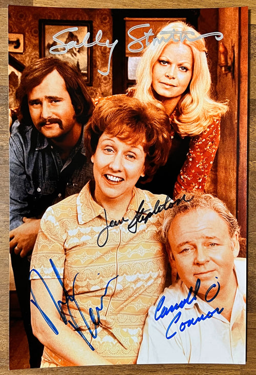 A cast autographed photo of the tv sitcom All in the Family. Signed poster by Carroll O'Connor, Jean Stapleton, Rob Reiner and Sally Struthers in silver black and blue ink markers signatures. Photograph autographs for sale on 8x12 inch picture.