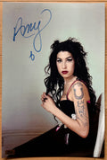 An autographed poster of rock and pop singer, Amy Winehouse. Signed photo in blue ink marker signatures. Photograph autographs for sale on 8x12 inch picture.