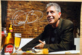 An autographed poster of celebrity chef, Anthony Bourdain. Signed photo in silver ink marker signatures. Photograph autographs for sale on 8x12 inch picture.