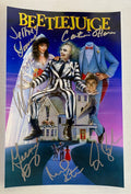 A cast autographed poster of the movie Beetlejuice. Signed photo of Michael Keaton, Winona Ryder, Geena Davis, Alex Baldwin, Catherine O'Hara and Jeffrey Jones in silver ink marker signatures. Photograph autographs for sale on 8x2 inch picture.