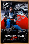 A cast autographed Beverly Hills Cop poster. Signed photo of Eddie Murphy, Judge Reinhold, Ronny Cox, John Ashton, Lisa Eilbacher, Steven Berkoff, James Russo and Jonathan Banks in silver ink marker signatures. Photograph autographs for sale on 8x12 inch picture.