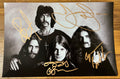 An autographed poster of the heavy metal band, Black Sabbath. Signed photo of Ozzy Osbourne, Tony Iommi, Bill Ward and Geezer Butler in gold marker ink signatures. Photograph autographs for sale on 8x12 inch picture.
