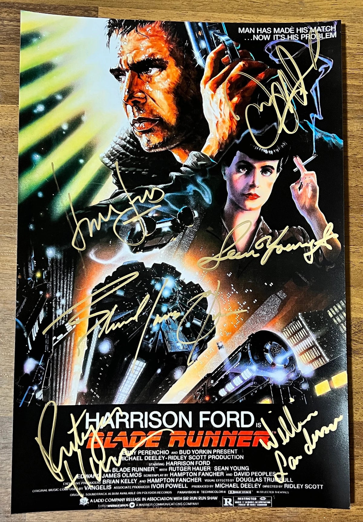 An autographed Blade Runner movie photo poster. Signed photograph of Harrison Ford, Rutger Hauer, Sean Young, Edward James Olmos, Daryl Hannah and William Sanderson in gold ink markers. Photograph autographs for sale on an 8x12 inch picture.
