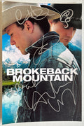 A cast signed movie poster for the film 'Brokeback Mountain'. Signed photo of Heath Ledger, Jake Gyllenhaal, Michelle Williams, Anne Hathaway and Randy Quaid in silver ink marker signatures. Photograph Heath Ledger autographs for sale on 8x12 inch picture.