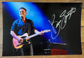 A poster signed by musician, Bruce Springsteen. Signed photo in silver ink marker signatures. Photograph autographs for sale on 8x12 inch picture.