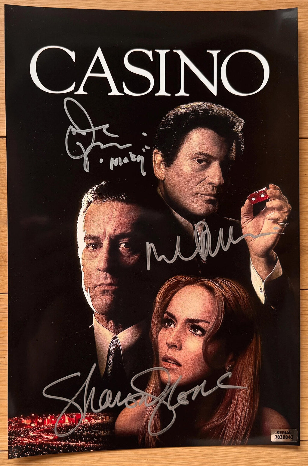 A cast signed Casino movie poster featuring the title 'CASINO'. Autographed photo by Robert De Niro, Joe Pesci (Added character name "Nicky"), and Sharon Stone in silver ink markers signatures. photograph autographs for sale on 8x12 inch picture.