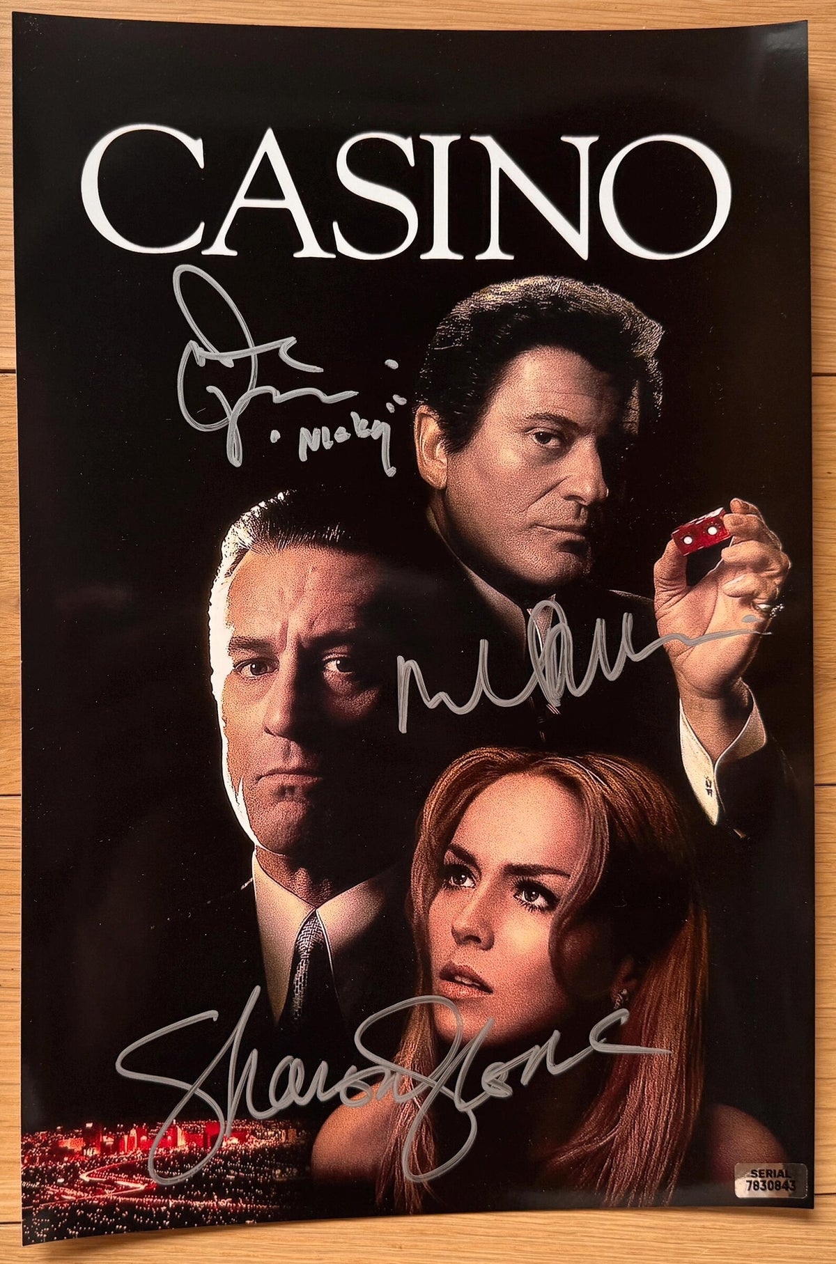 A cast signed Casino movie poster featuring the title 'CASINO'. Autographed photo by Robert De Niro, Joe Pesci (Added character name "Nicky"), and Sharon Stone in silver ink markers signatures. photograph autographs for sale on 8x12 inch picture.