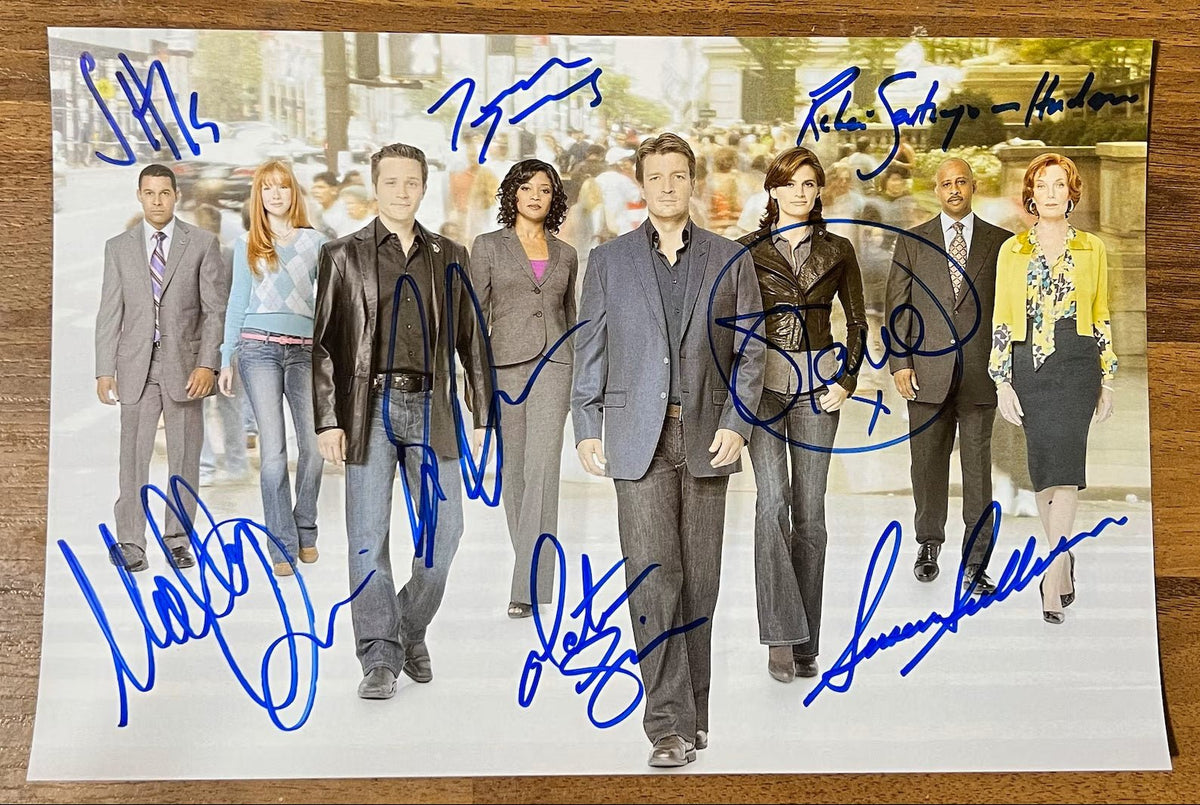 A cast autographed poster of the television series, Castle. Signed photo of Stana Katic, Nathan Fillion, Ruben Santiago-Hudson, Molly C. Quinn, Susan Sullivan, Seamus Dever and Jon Huertas in blue ink marker signatures. Photograph autographs for sale on 8x12 inch picture.