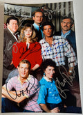 A cast autographed photo poster of the sitcom series, Cheers. Signed poster by Ted Danson, Kelsey Grammer, Rhea Perlman, John Ratzenberger, George Wendt, Woody Harrelson and Shelley Long in various color markers signatures. photograph Cheers autographs for sale on an 8x12 inch picture.