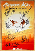 A cast autographed poster of television series Cobra Kai. Signed photo of Ralph Macchio, William Zabka, Xolo Mariduena, Martin Cove, Mary Mouser, Courtney Henggeler, Tanner Buchanan and Jacob Bertrand in black ink marker signatures. Photograph Cobra Kai autographs for sale on 8x12 inch picture.