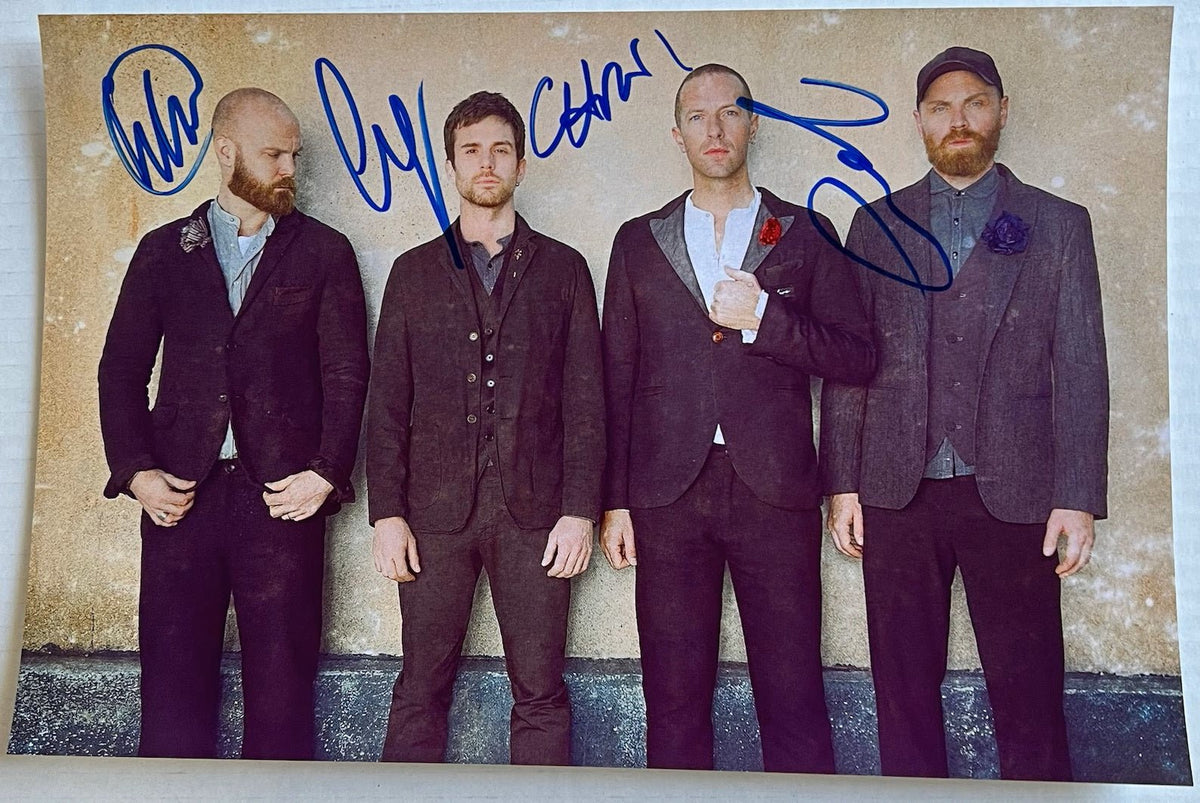 autographed photo of the band Coldplay. autograph signed by Chris Martin, Jonny Buckland, Guy Berryman and Will Champion in blue ink on 8x12 inch photograph poster coldplay autographs for sale.