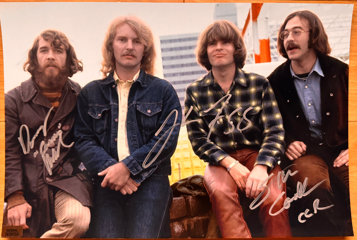 An autographed poster of the rock band Creedence Clearwater Revival also known as CCR. Signed photo of John Fogerty, Stu Cook and Doug Clifford in silver ink signatures. Photograph ccr autographs for sale on 8x12 inch picture.