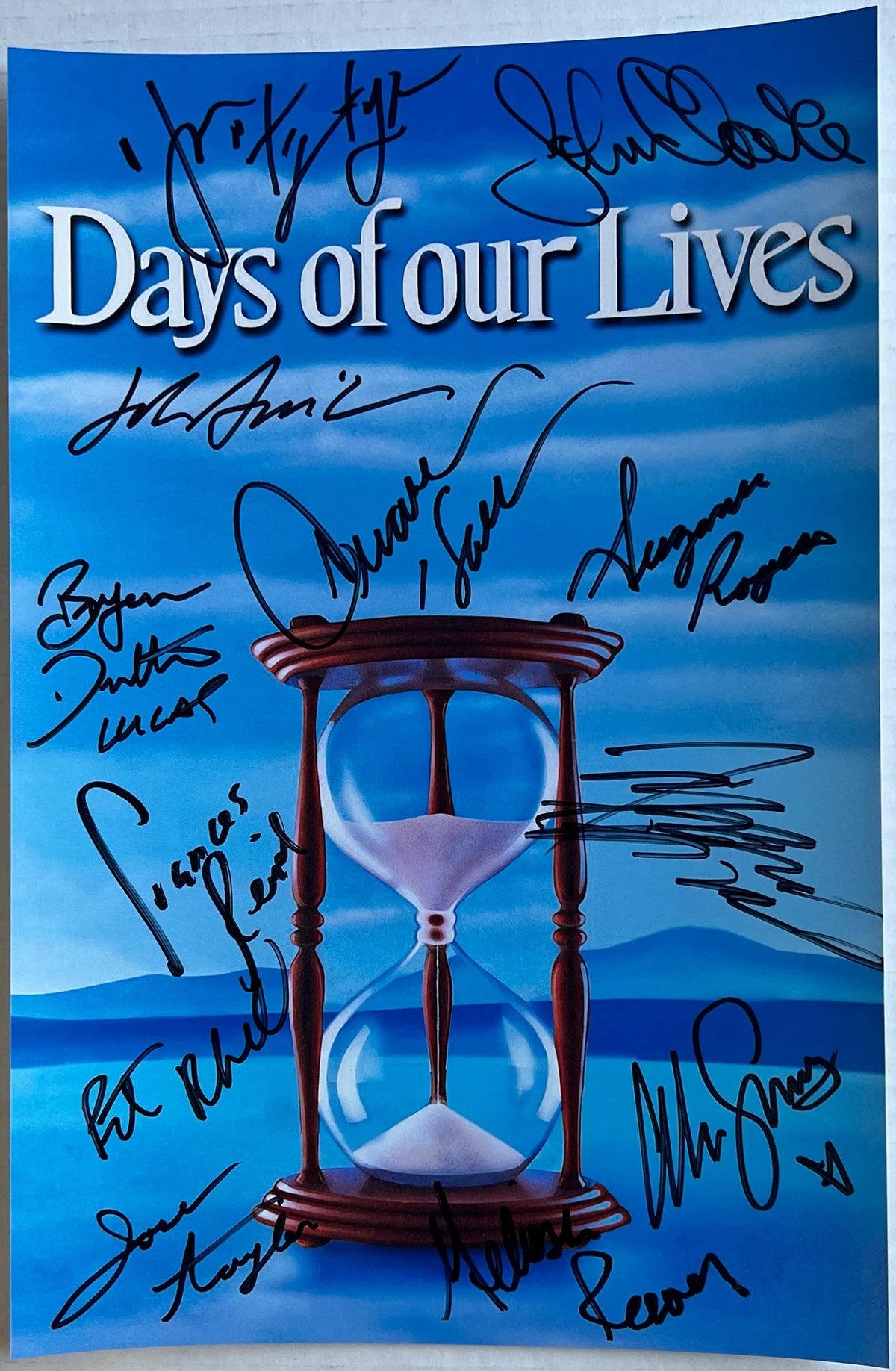 A cast autographed photo poster of the television soap opera series, The Days of Our Lives. Signed photo of Deidre Hall, Alison Sweeney, Frances Reid, Kristian Alfonso, Drake Hogestyn, John Clarke, John Aniston, Josh Taylor, Suzanne Rogers, Peter Reckell, Bryan Datillo and Melissa Reeves in black ink marker signatures. Photograph autographs for sale on 8x12 inch picture.