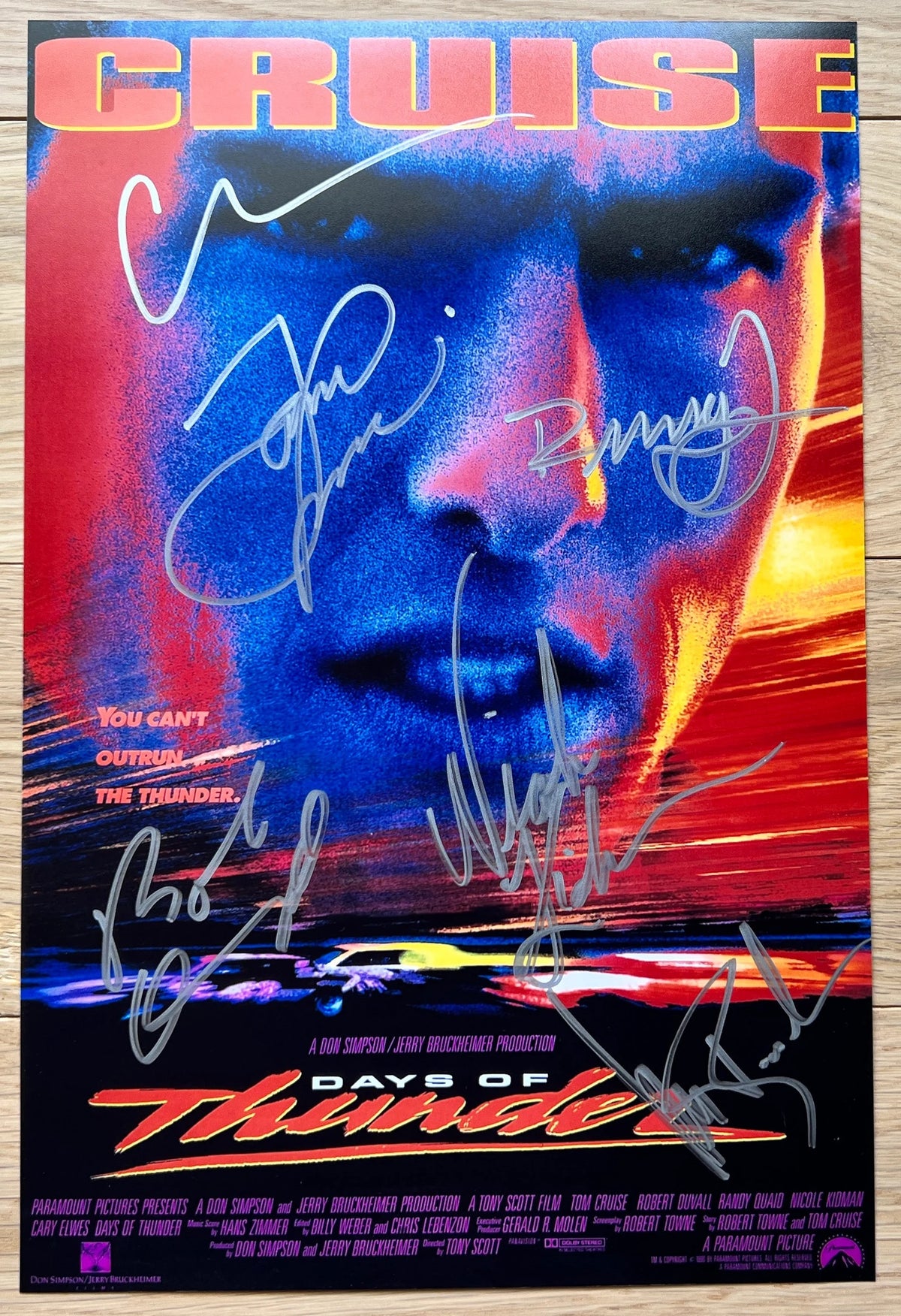 A cast autographed photo poster from the movie, Days of Thunder. Signed photo of Tom Cruise, Nicole Kidman, Robert Duvall, Randy Quaid, Cary Elwes and Michael Rooker in silver ink marker signatures. Photograph autographs for sale on 8x12 inch picture.