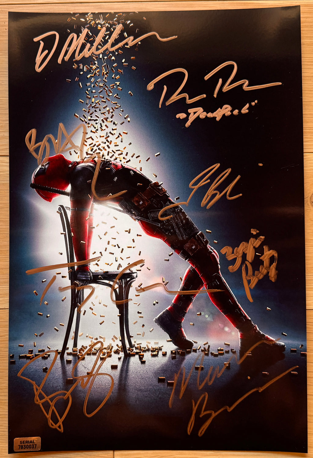 A cast autographed poster of the super hero movie Deadpool. Signed photo of Ryan Reynolds, Morena Baccarin, T.J. Miller, Josh Brolin, Brianna Hildebrand, Zazie Beetz, Bill Skarsgard and Terry Crews in gold ink marker signatures. Photograph autographs for sale on 8x12 inch picture.