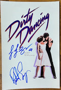 A cast autographed poster of the movie Dirty Dancing. Signed photo of Patrick Swayze and Jennifer Grey in blue ink marker signatures. Photograph autographs for sale on 8x12 inch picture.