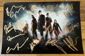 A cast autographed photo poster from the tv series Doctor Who. Signed photograph of David Tennant, Matt Smith, John Hurt, Karen Gillan, Billie Piper, Jenna Coleman, Peter Capaldi, John Barrowman, Freema Agyeman, Paul Kasey, Catherine Tate, Nicholas Briggs and Arthur Darvill in gold ink markers signatures. Photograph autographs for sale on 8x12 inch picture.