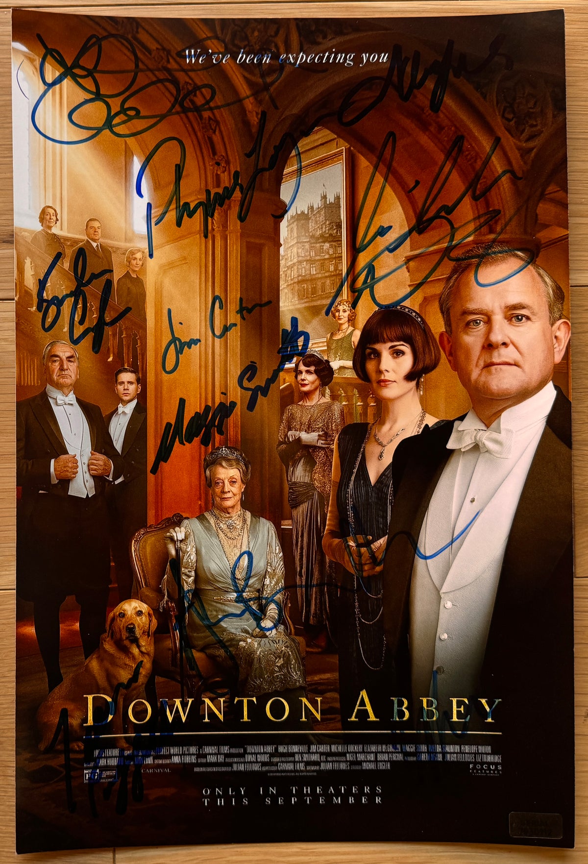 A cast autographed poster of the television series movie, Downton Abbey. Signed photo of Hugh Bonneville, Laura Carmichael, Jim Carter, Brendan Coyle, Michelle Dockery, Joanne Froggatt, Phyllis Logan, Elizabeth McGovern, Maggie Smith and Allen Leech in blue ink marker signatures. Photograph autographs for sale on 8x12 inch picture.