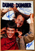 A cast autographed poster of the movie Dumb and Dumber from 1994. Signed photo of Jim Carrey, Jeff Daniels, Lauren Holly, Mike Starr, Karen Duffy and Charles Rocket in blue ink marker signatures. Photograph autographs for sale on 8x12 inch picture.