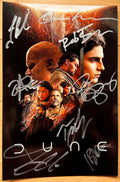 A cast autographed 'Dune' 2001 movie poster. Signed photo of Timothee Chalamet, Zendaya, Josh Brolin, Jason Momoa, Stellan Skarsgard, Rebecca Ferguson, Oscar Isaac and Javier Bardem in silver ink marker signatures. Photograph autographs for sale on 8x12 inch picture.