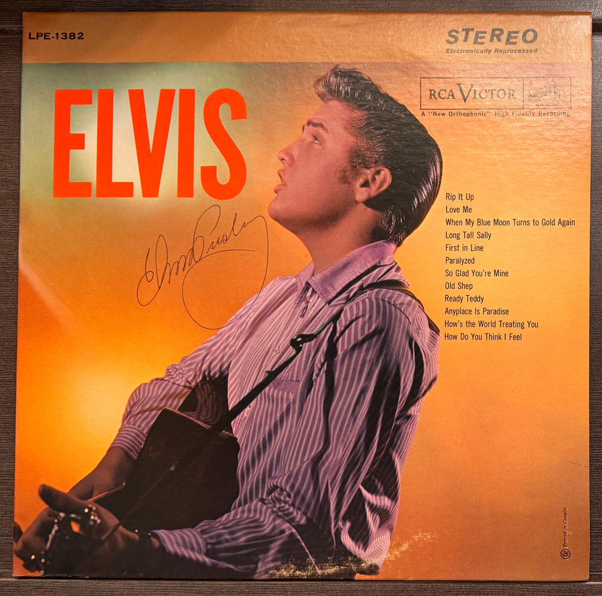an autographed self-titled record album LP of Elvis Presley. signed in blue ink on the front cover. autograph in mint condition with certificate of authenticity. 