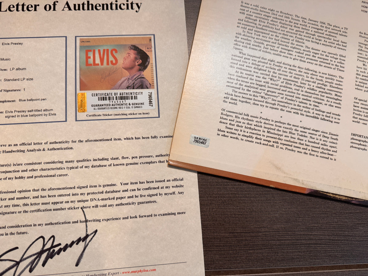 an autographed self-titled record album LP of Elvis Presley. signed in blue ink on the front cover. autograph in mint condition with certificate of authenticity with COA.
