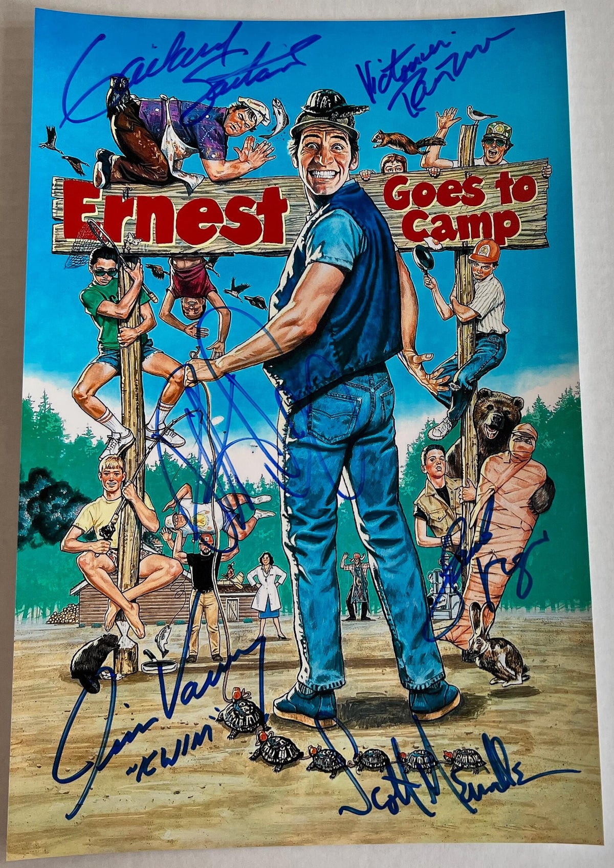 A cast autographed photo poster of the movie Ernest Goes to Camp. Signed poster of Jim Varney, Victoria Racimo, Gailard Sartain, Patrick Day, Scott Menville and Jacob Vargas in blue ink markers signatures. Photograph Jim Varney autographs for sale on 8x12 inch picture.