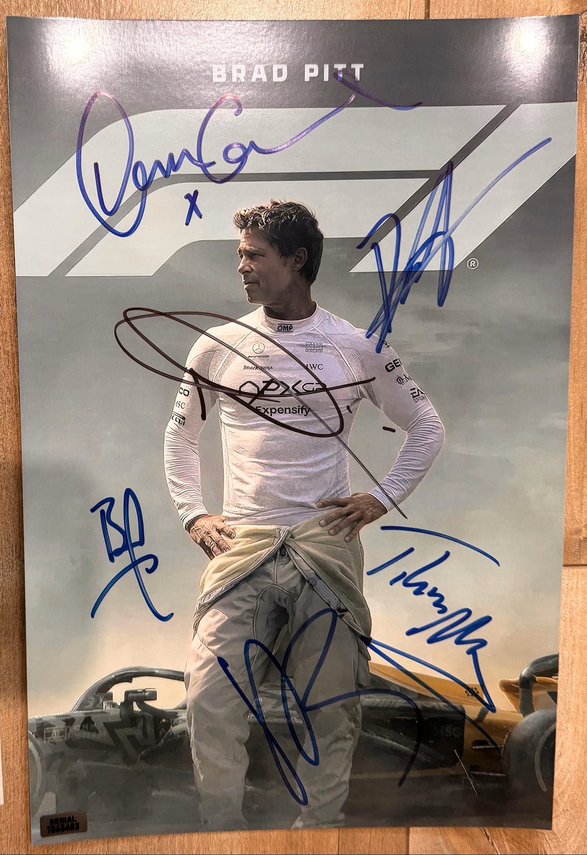 A cast autographed poster of the movie F1. Signed photo of Brad Pitt, Damson Idris, Kerry Condon, Tobias Menzies, Javier Bardem, Joseph Kosinski in blue and black ink marker signatures. Photograph autographs for sale on 8x12 inch picture.