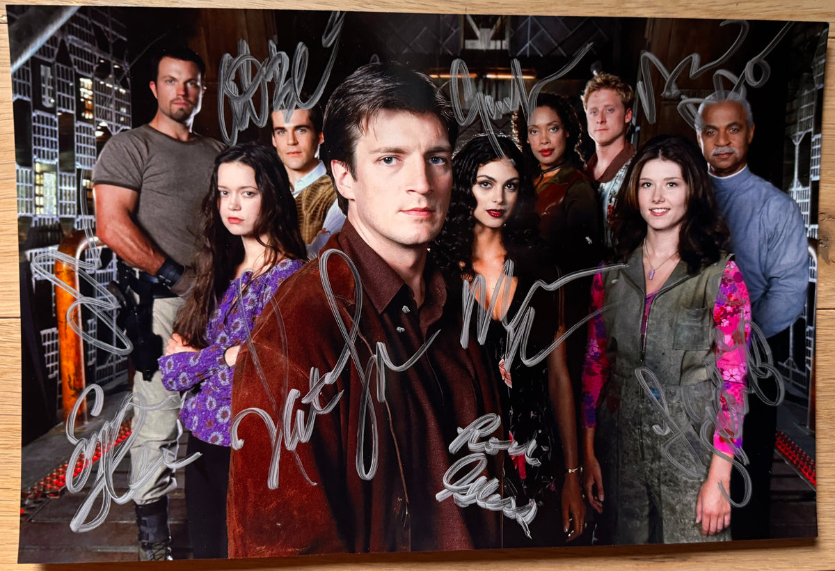 A cast autographed photo poster of the cast of the TV show 'Firefly'. Signed photograph of Nathan Fillion, Morena Baccarin, Gina Torres, Alan Tudyk, Adam Baldwin, Jewel Staite, Sean Maher, Summer Glau and Ron Glass in silver ink markers. Photograph autographs for sale on an 8x12 inch picture 