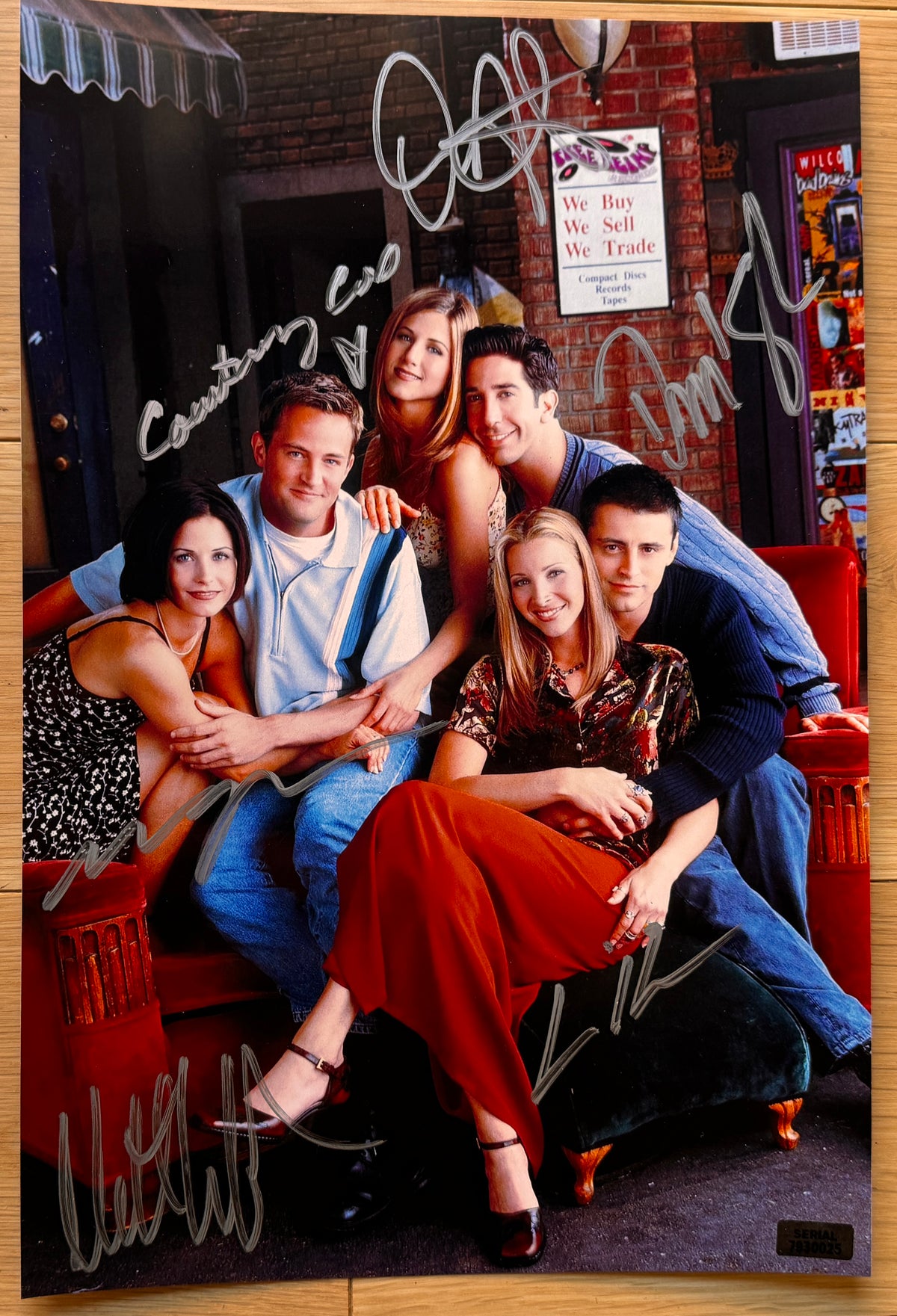 A cast autographed poster of the television show Friends. Signed photo of Jennifer Aniston, Matt Perry, Courteney Cox, Lisa Kudrow, Matt Leblanc and David Schwimmer in silver ink markers. Photograph autographs for sale on 8x12 inch picture.