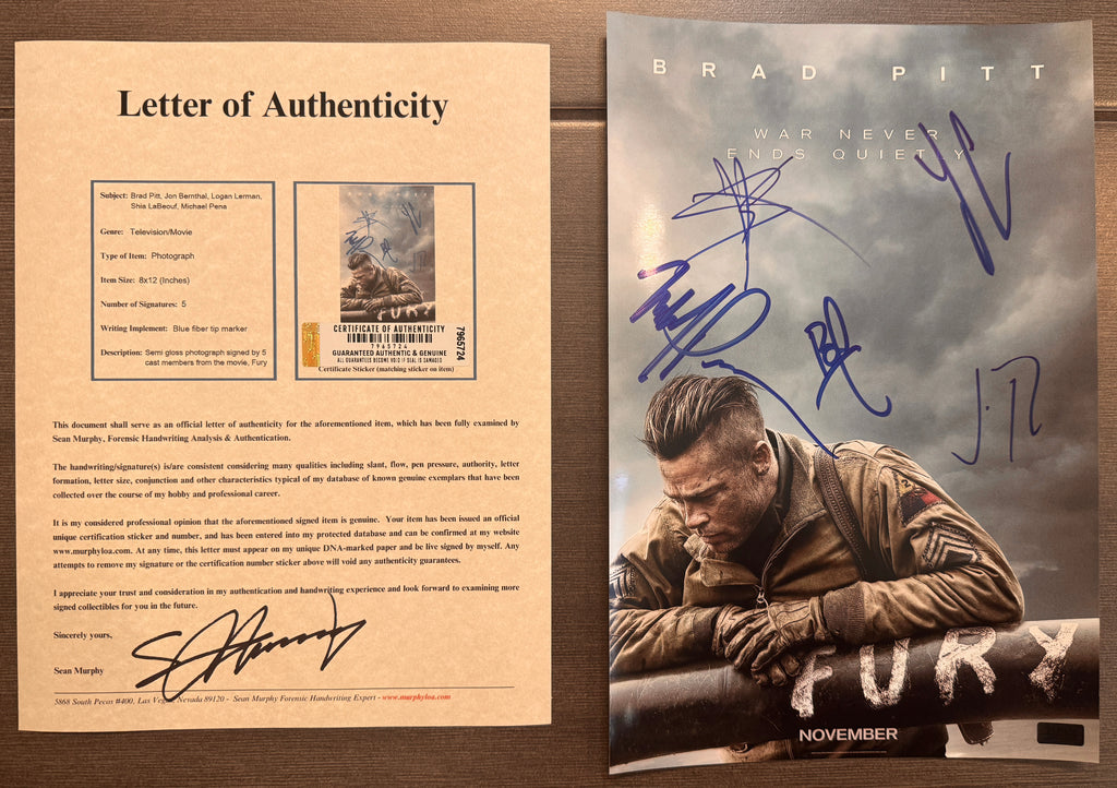 A cast autographed photo poster of the 2014 war movie, Fury. Signed photograph of Brad Pitt, Shia LaBeouf, Jon Bernthal, Logan Lerman and Michael Pena in blue ink marker signatures. Photograph Fury autographs for sale on 8x12 inch picture with COA.
