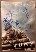 A cast autographed photo poster of the 2014 war movie, Fury. Signed photograph of Brad Pitt, Shia LaBeouf, Jon Bernthal, Logan Lerman and Michael Pena in blue ink marker signatures. Photograph Fury autographs for sale on 8x12 inch picture.