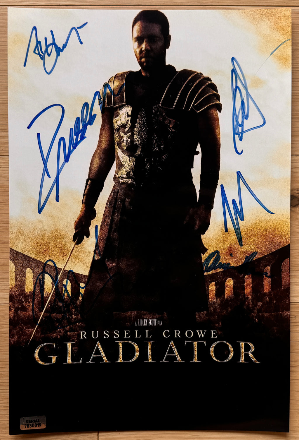 A cast autographed movie poster of the movie, Gladiator. Signed photo of Russell Crowe, Joaquin Phoenix, Connie Nielsen, Oliver Reed, Richard Harris and Djimon Hounsou in blue ink marker signatures. photograph autographs for sale on 8x12 inch picture.