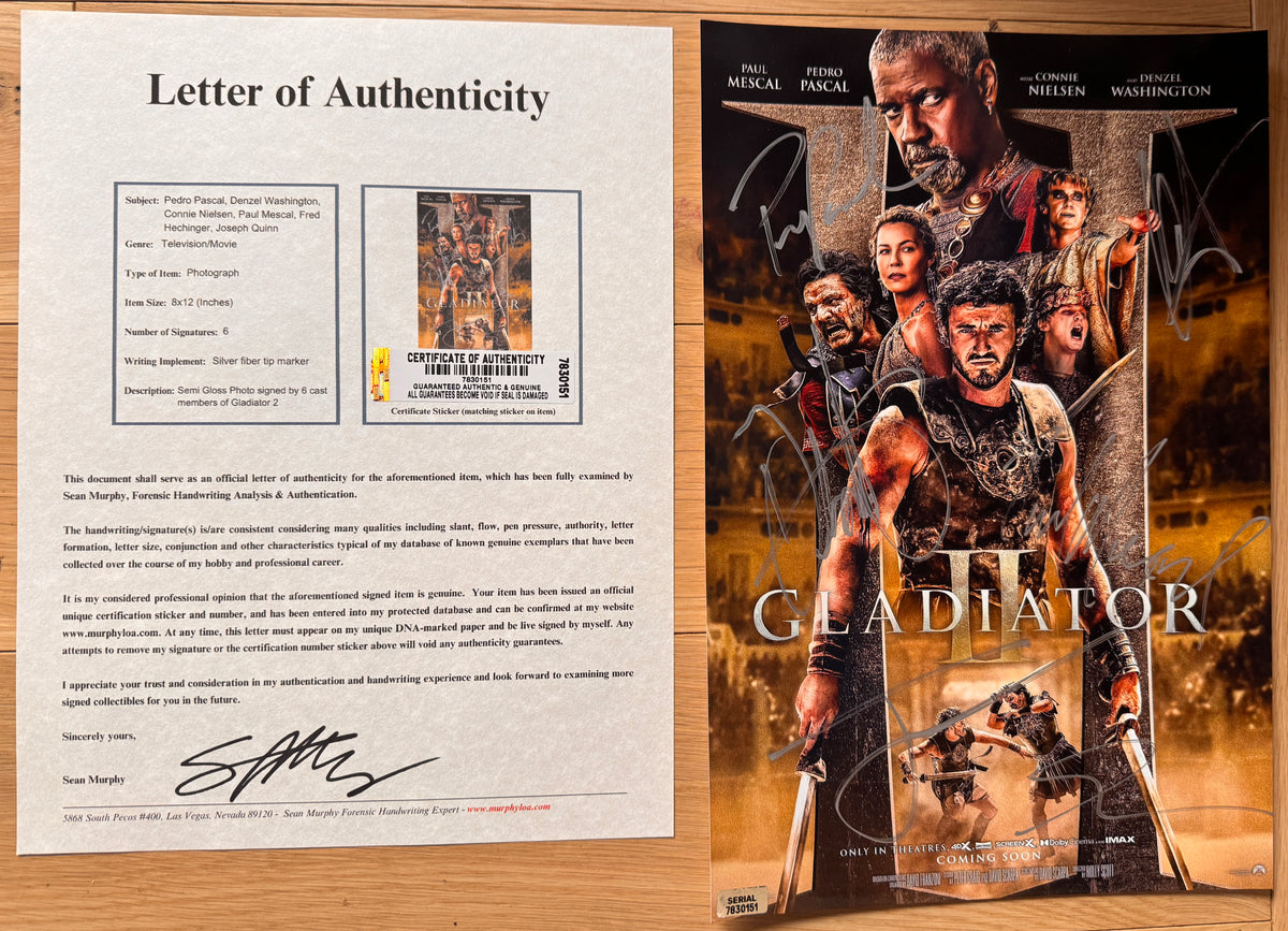 An autographed Gladiator movie poster featuring Paul Mescal, Pedro Pascal, Conne Nielsen, and Denzel Washington, with multiple silver signatures across the front. signed poster and photograph autographs for sale with COA.