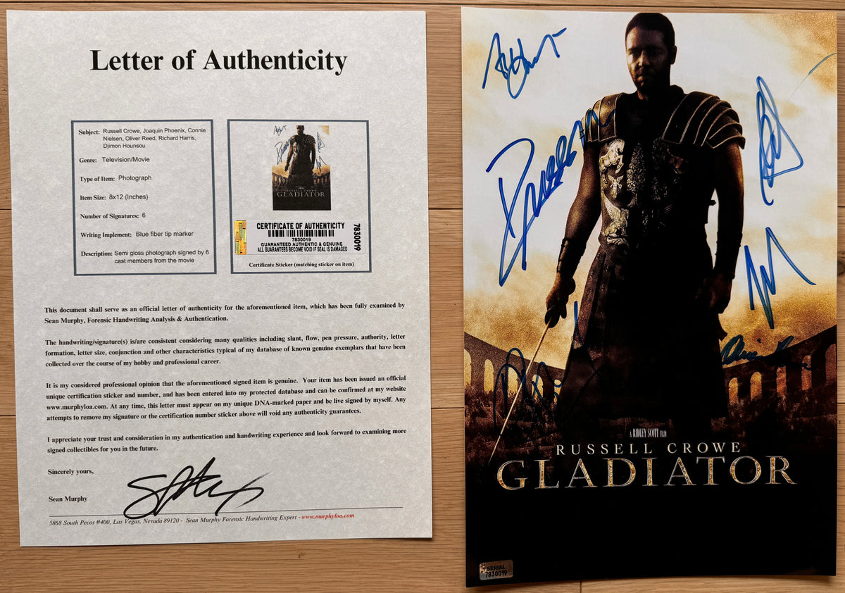 An autographed movie poster of Russell Crowe as Maximus from the film Gladiator, signed photo of Russell Crowe, Joaquin Phoenix, Connie Nielsen, Oliver Reed, Richard Harris and Djimon Hounsou in blue ink. photograph autographs for sale. 8x12 inch picture with COA.