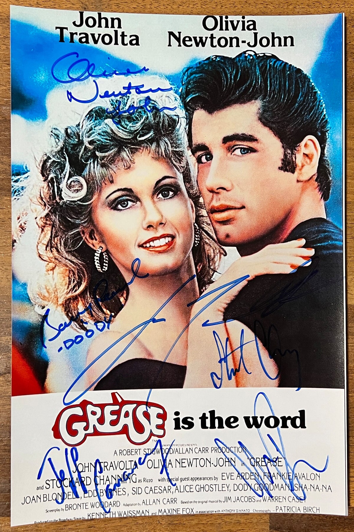 A cast autographed photo poster from the movie, Grease. Signed photo of John Travolta, Olivia Newton-John, Stockard Channing, Jeff Conaway, Barry Pearl and Michael Tucci in blue ink marker signatures. Photograph autographs for sale on 8x12 inch picture.