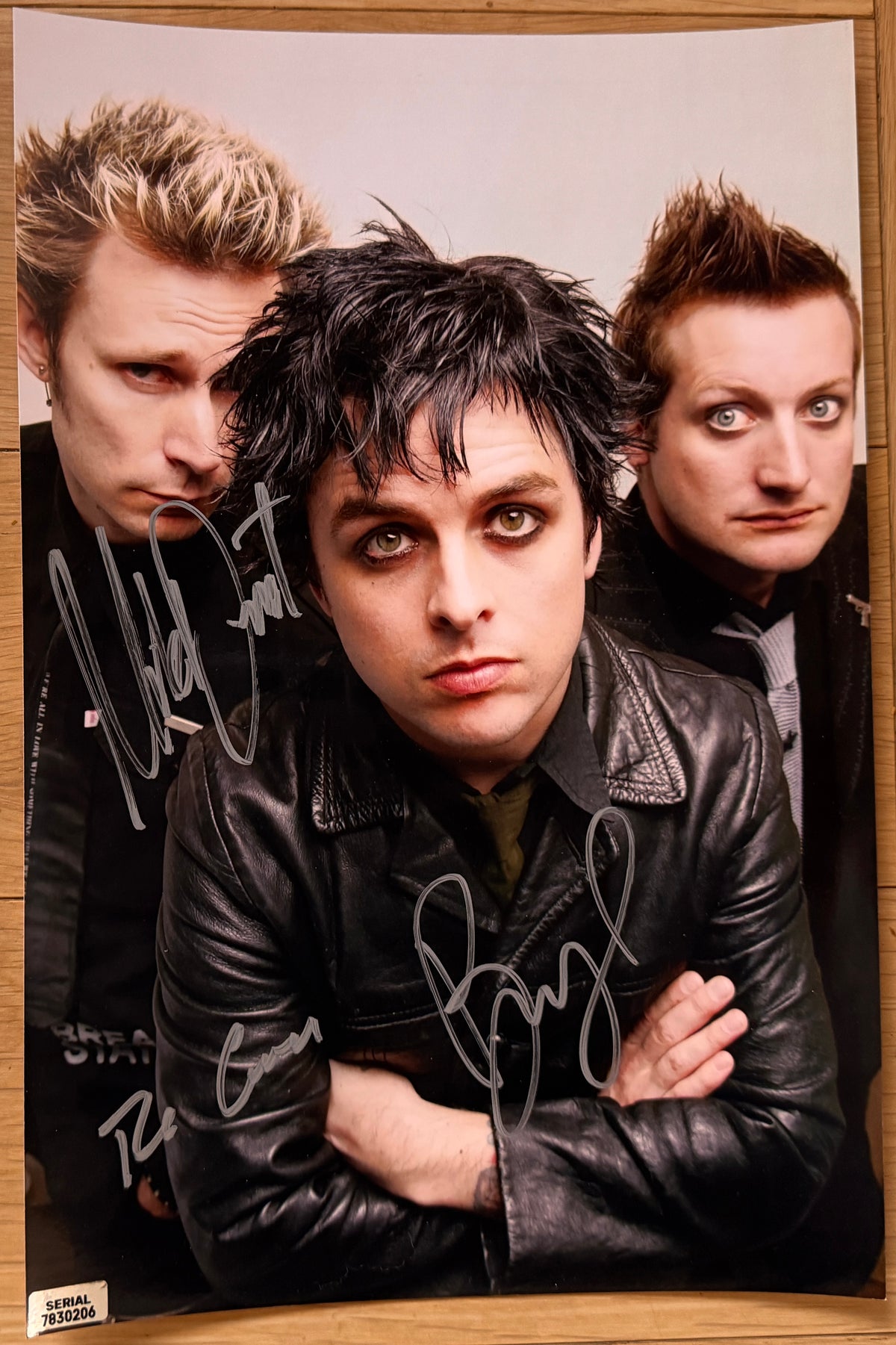 An autographed photo poster of the rock band, Green Day. Signed photo of Billie Joe Armstrong, Mike Dirnt and Tre Cool in silver ink marker signatures. Photograph autographs for sale on 8x12 inch picture.