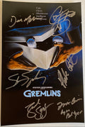 A cast autographed photo poster from the movie, Gremlins. Signed photo of Zach Galligan, Steven Spielberg, Phoebe Cates, Corey Feldman, Dick Miller and Frances Lee McCain in silver ink marker signatures. Photograph autographs for sale on 8x12 inch picture.