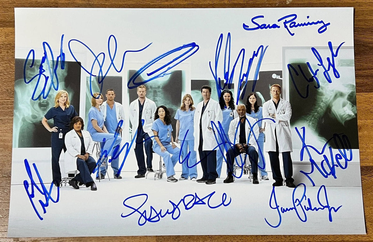 A cast autographed 8x12 photo print of the TV show 'Grey's Anatomy'. Signed photo of Ellen Pompeo, Patrick Dempsey, Sandra Oh, Justin Chambers, Katherine Heigl, Chandra Wilson, Jessica Capshaw, Eric Dane, Sara Ramirez, James Pickens Jr, Chyler Leigh and Kevin McKidd in blue ink marker signatures. Photograph autographs for sale on 8x12 inch picture.