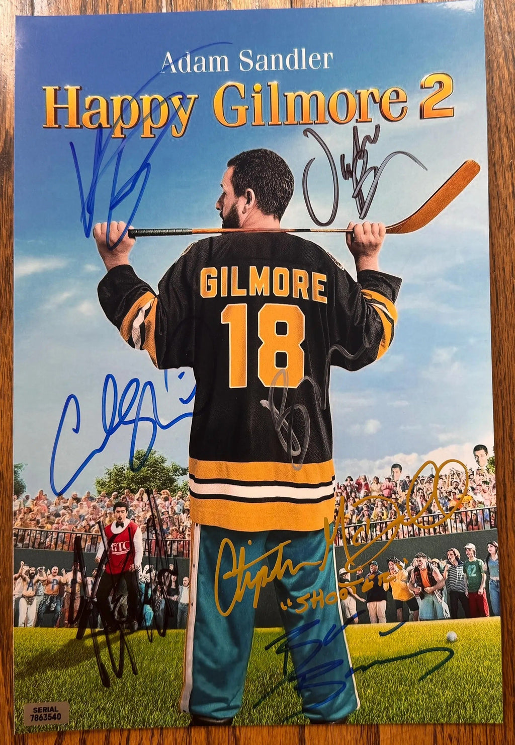 A cast autographed photo print of the movie 'Happy Gilmore 2'. Signed poster by Adam Sandler, Julie Bowen, Christopher McDonald, Ben Stiller, Benny Safdie, Bad Bunny and Kyle Newacheck in black silver gold blue ink markers. Photograph autographs for sale on 8x12 inch picture.