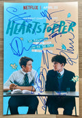 A cast autographed Netflix photo poster for the TV series 'Heartstopper', Signed photo by Joe Locke, Kit Connor, Yasmin Finney, William Gao, Cormac Hyde-Corrin, Tobie Donovan, Rhea Norwood and Sebastian Croft in blue ink marker signatures. photograph Heartstopper autographs for sale on picture.