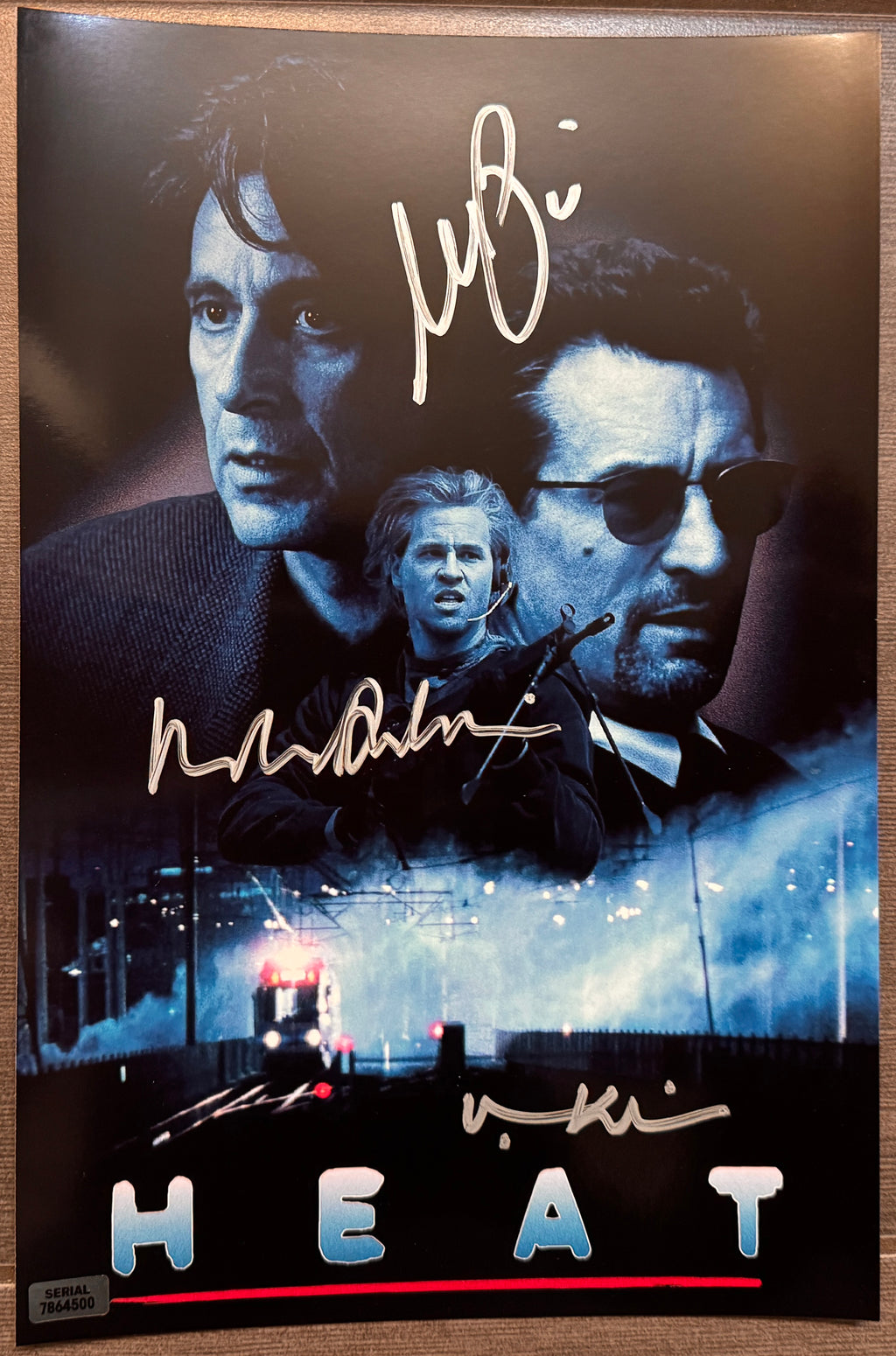 A cast autographed poster of the movie, Heat. Signed photo of Robert De Niro, Al Pacino and Val Kilmer in silver ink marker signatures. Photograph autographs for sale on 8x12 inch picture.