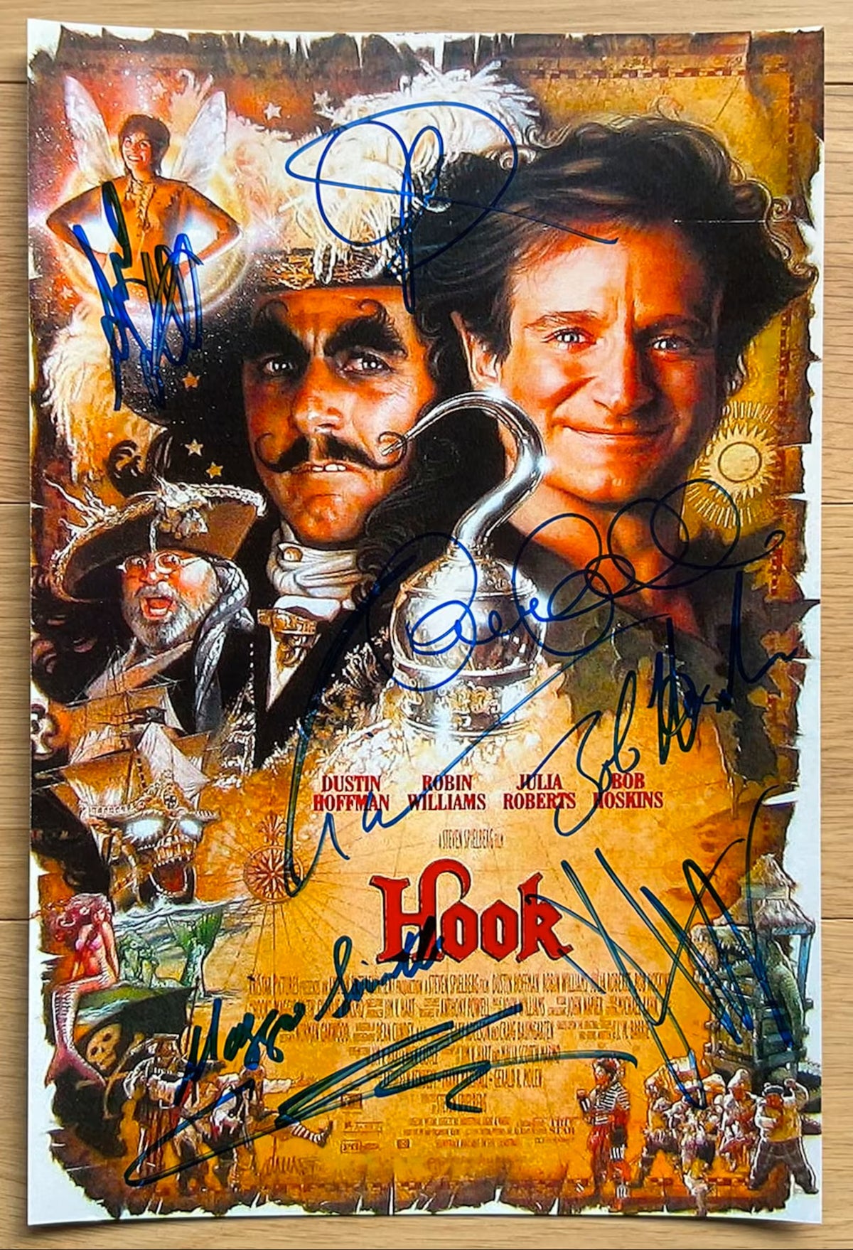 A cast autographed poster photo of the movie, Hook. Signed photograph of Robin Williams, Julia Roberts, Dustin Hoffman, Bob Hoskins, Maggie Smith, Caroline Goodall, Charlie Korsmo and Amber Scott in blue ink marker signatures. Photograph autographs for sale on 8x12 inch picture.