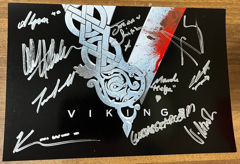 A cast autographed Vikings cast signed 8x12 photo. poster autographed by Katheryn Winnick, Travis Fimmel, Alexander Ludwig, Gustaf Skarsgard, Georgia Hirst, Alex Hogh Andersen, Jordan Patrick Smith, Clive Standen, Maude Hirst and Alyssa Sutherland in silver ink markers signatures. photograph autographs for sale on 8x12 inch picture.