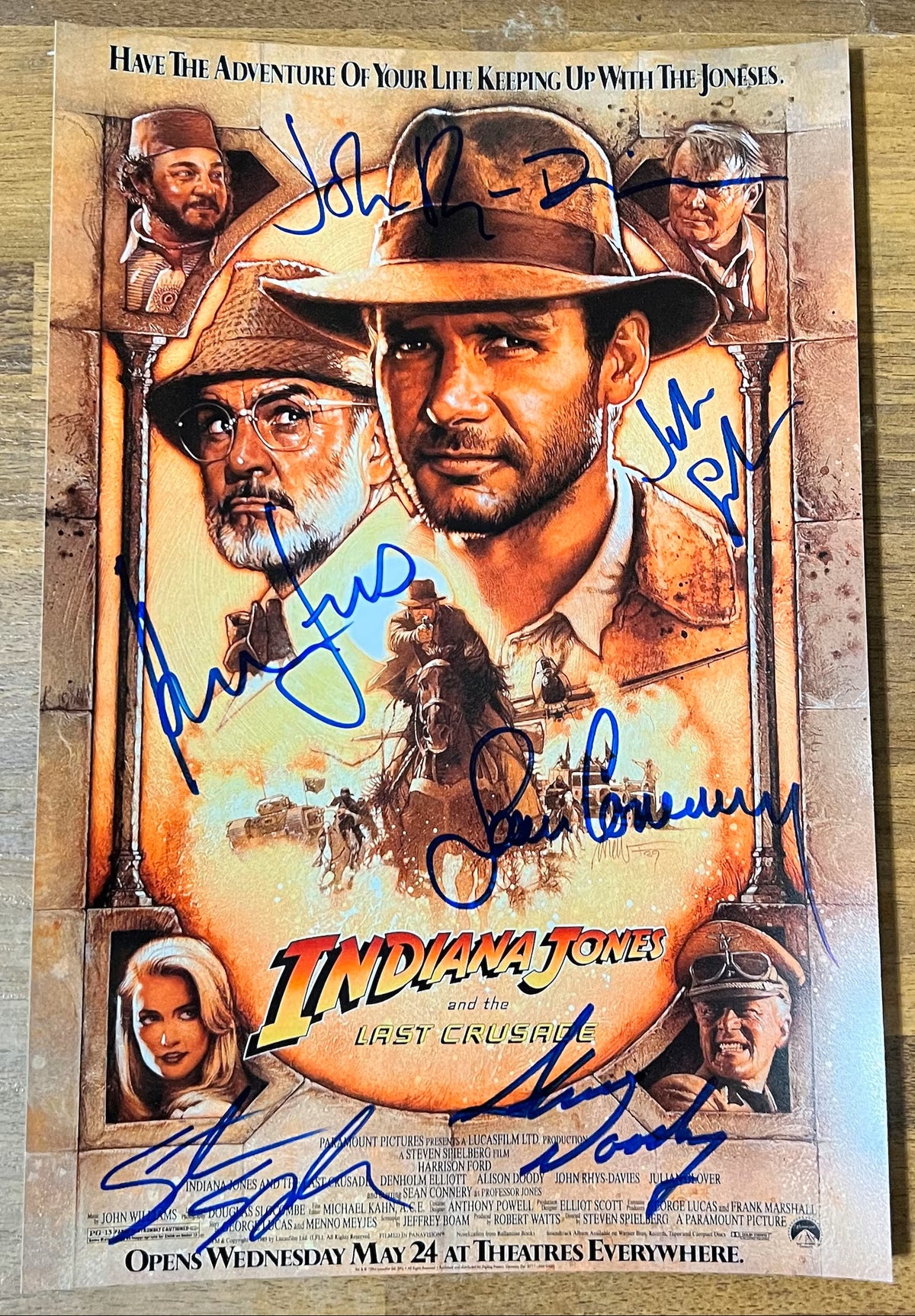 A cast autographed poster of the movie, Indiana Jones and the Last Crusade. Signed photo of Harrison Ford, Sean Connery, John Rhys-Davies, Alison Doody, Julian Glover and Steven Spielberg in blue ink marker signatures. Photograph autographs for sale on 8x12 inch picture.