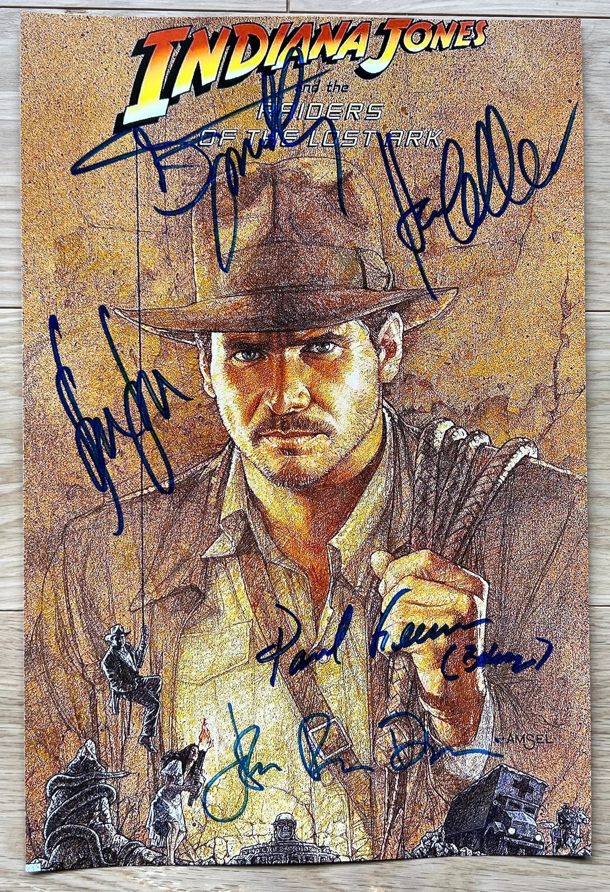 A cast autographed poster of the movie, Indiana Jones and the Raiders of the Lost Ark. Signed photo of Harrison Ford, Karen Allen, Steven Spielberg, Paul Freeman and John Rhys-Davies in blue ink marker signatures. Photograph autographs for sale on 8x12 inch picture.